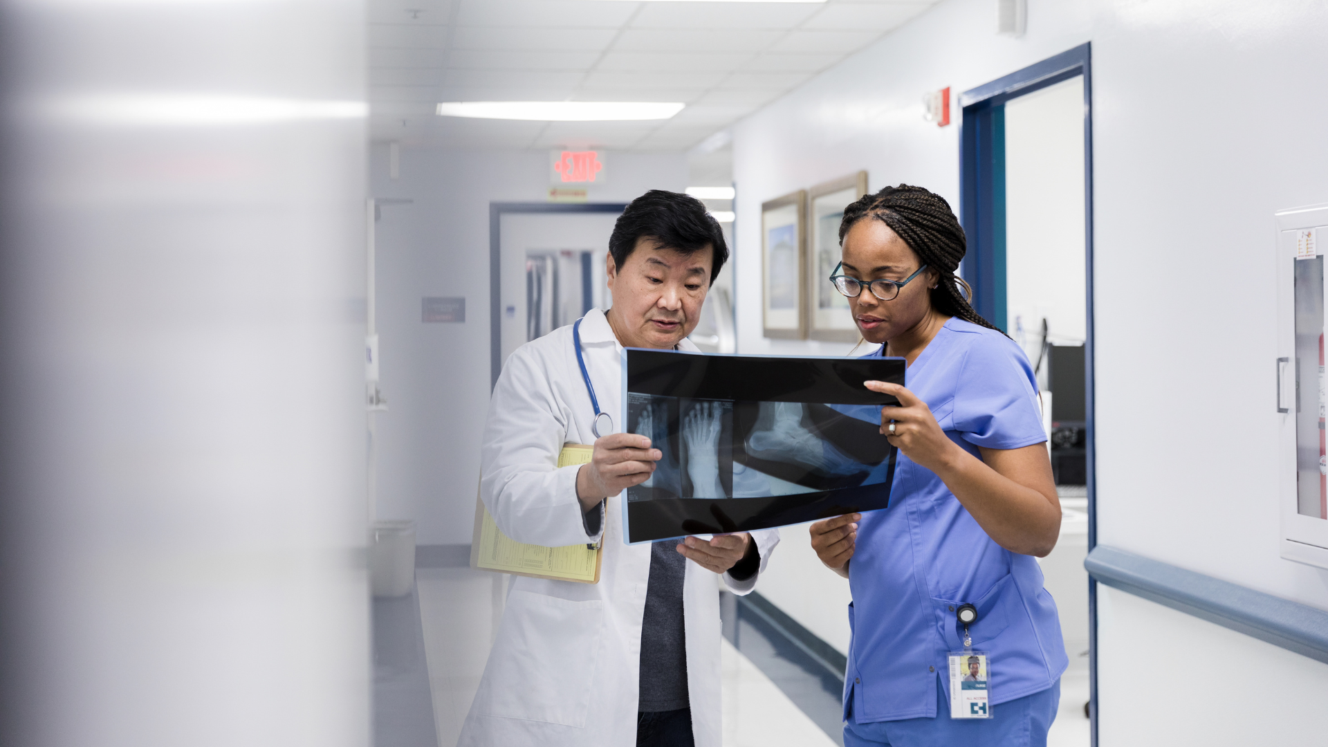 Doctor and nurse examining a x ray showcasing what are the orthopaedic issues related to spina bifida