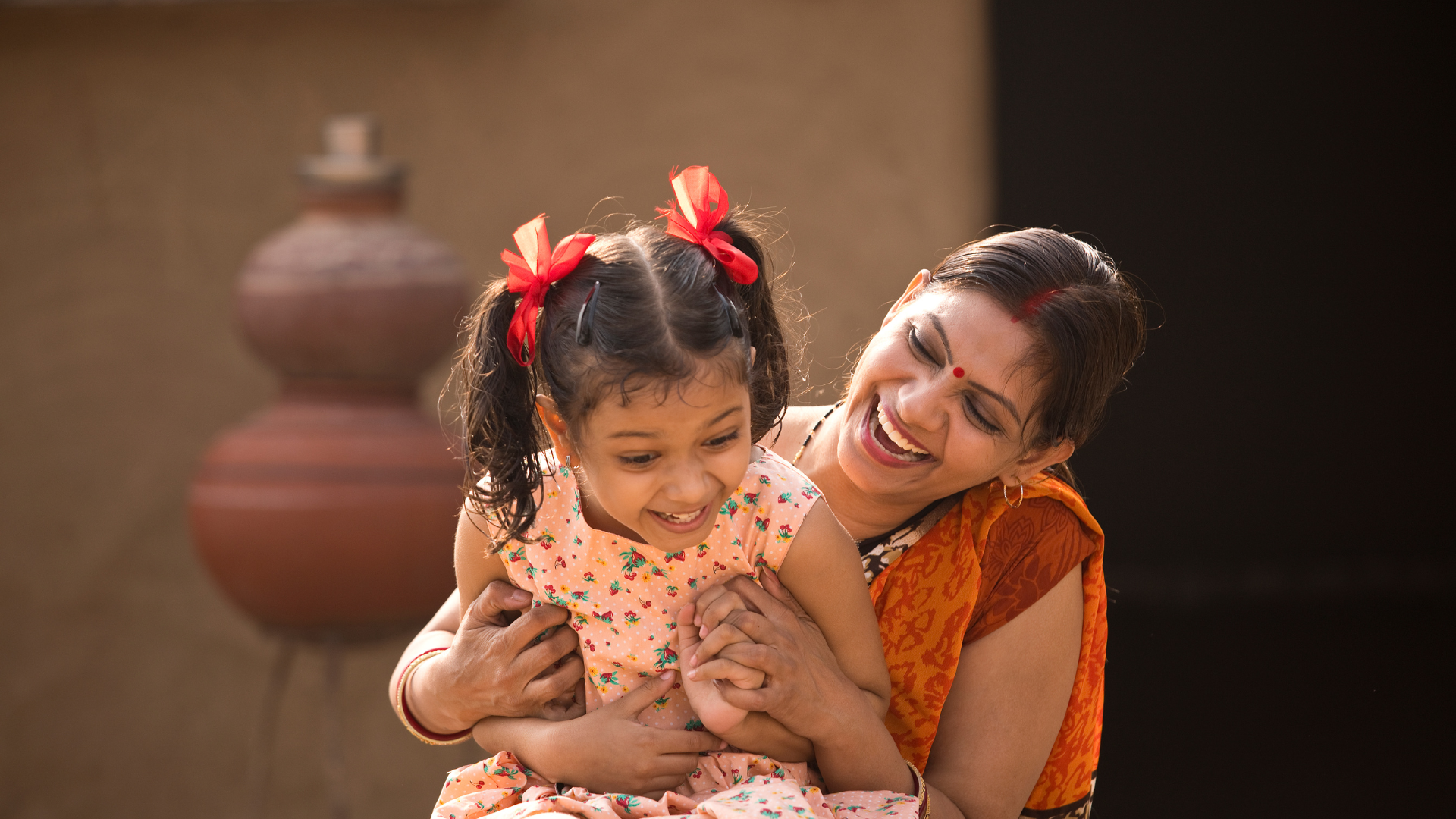 a woman smiling with her child in our categories search page