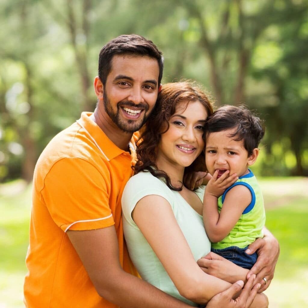 a young couple with their boy child encouraging people tp donate for spina bifida cause